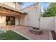 Backyard featuring a brick-lined fire pit, patio, string lights and artificial turf at 1718 S Longmore -- # 41, Mesa, AZ 85202