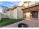 Backyard featuring a brick-lined fire pit, patio, string lights and artificial turf at 1718 S Longmore -- # 41, Mesa, AZ 85202