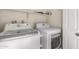 Functional laundry room equipped with modern, white washer and dryer units at 1718 S Longmore -- # 41, Mesa, AZ 85202
