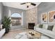 Bright living room with a stone fireplace, a large window, and contemporary furniture at 1718 S Longmore -- # 41, Mesa, AZ 85202