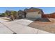 Charming one-story home features a two car garage, desert landscaping, and a cozy front porch at 17583 W Paraiso Dr, Surprise, AZ 85387