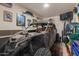 View of a well-organized garage featuring a black ATV, tools, and wall decorations at 17583 W Paraiso Dr, Surprise, AZ 85387