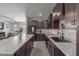 Modern kitchen boasts sleek countertops, dark cabinetry, stainless appliances, and an open layout at 17583 W Paraiso Dr, Surprise, AZ 85387