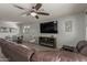 Comfortable living room featuring modern furniture, a large TV, and an open layout to the dining area at 17583 W Paraiso Dr, Surprise, AZ 85387