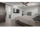 The primary bedroom features a TV, wood-look floors, and an en-suite bathroom with dual vanities at 17583 W Paraiso Dr, Surprise, AZ 85387