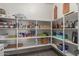 Organized walk-in pantry with multiple shelves for ample storage, keeping your kitchen tidy at 17583 W Paraiso Dr, Surprise, AZ 85387