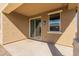 Covered outdoor patio with a sliding glass door and a view of the well-maintained backyard at 17583 W Paraiso Dr, Surprise, AZ 85387