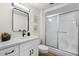 Stylish bathroom features a shower, modern vanity, decorative mirror, and neutral walls at 17615 N Whispering Oaks Dr, Sun City West, AZ 85375