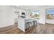 Kitchen island with white cabinets, stainless steel appliances and seating at 17615 N Whispering Oaks Dr, Sun City West, AZ 85375