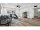 Living room with hardwood floors, ceiling fan, a comfortable gray sofa, and modern decor at 17615 N Whispering Oaks Dr, Sun City West, AZ 85375