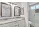 Bathroom featuring double sinks with granite countertops and a glass-enclosed shower at 1822 S 39Th St # 17, Mesa, AZ 85206