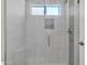 Modern bathroom shower with glass door, bronze fixtures, and window at 1822 S 39Th St # 17, Mesa, AZ 85206