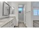 Bright bathroom with granite countertop, double sinks, and a glass shower at 1822 S 39Th St # 17, Mesa, AZ 85206