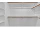 A well-organized walk-in closet with wooden rods and shelves at 1822 S 39Th St # 17, Mesa, AZ 85206