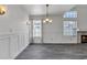 Bright living room with wainscoting, chandelier, and views of the fireplace at 1822 S 39Th St # 17, Mesa, AZ 85206
