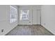 Bright room with wood-look tile flooring, wainscoting, a window with blinds, and a sliding door closet at 1822 S 39Th St # 17, Mesa, AZ 85206
