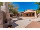Backyard featuring a unique outdoor fireplace, comfortable seating, and views of the home's architecture at 19405 W Oregon Ave, Litchfield Park, AZ 85340