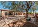 Private backyard with mature tree, comfortable seating areas, and an extended patio perfect for outdoor gatherings at 19405 W Oregon Ave, Litchfield Park, AZ 85340