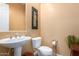Powder room showcasing pedestal sink, white fixtures, and neutral wall color at 19405 W Oregon Ave, Litchfield Park, AZ 85340