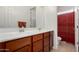 Bathroom features double sinks with wood cabinetry, a large mirror, and a shower with a curtain at 19405 W Oregon Ave, Litchfield Park, AZ 85340