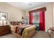 Cozy bedroom with earth-toned decor, decorative pillows, and a complementary turquoise colored table at 19405 W Oregon Ave, Litchfield Park, AZ 85340