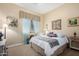Inviting bedroom boasts soft decor, a comfortable bed, and matching side tables with lamps at 19405 W Oregon Ave, Litchfield Park, AZ 85340