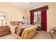 Comfortable bedroom featuring a decorative window and light-colored walls at 19405 W Oregon Ave, Litchfield Park, AZ 85340