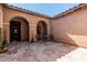 Private tiled front courtyard with arches and outdoor seating at 19405 W Oregon Ave, Litchfield Park, AZ 85340