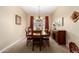 Formal dining room showcasing a wooden table with chairs, chandelier, and sideboard cabinet at 19405 W Oregon Ave, Litchfield Park, AZ 85340