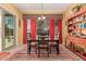 Dining room with rustic table and chairs, bright area rug, and sliding glass door to patio at 19405 W Oregon Ave, Litchfield Park, AZ 85340