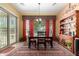 Inviting dining area with a wooden table set, patterned rug, and a sliding glass door to the exterior at 19405 W Oregon Ave, Litchfield Park, AZ 85340