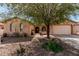 Charming single-story home featuring desert landscaping, covered entry, and a two-car garage at 19405 W Oregon Ave, Litchfield Park, AZ 85340