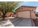 Driveway to a large 2 car garage with desert landscaping at 19405 W Oregon Ave, Litchfield Park, AZ 85340