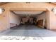Spacious open garage, with an entrance door, offering ample space for vehicles and storage at 19405 W Oregon Ave, Litchfield Park, AZ 85340