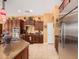 Kitchen with stainless steel appliances, island with granite countertops, and wooden cabinets at 19405 W Oregon Ave, Litchfield Park, AZ 85340