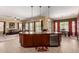 Spacious kitchen features a central island, seating, and overlooks living and dining spaces at 19405 W Oregon Ave, Litchfield Park, AZ 85340