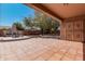 Large covered patio with tiled flooring and stone fireplace, perfect for entertaining at 19405 W Oregon Ave, Litchfield Park, AZ 85340