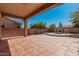Spacious covered patio with terracotta tile, fireplace and citrus tree at 19405 W Oregon Ave, Litchfield Park, AZ 85340