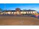 Beautiful community clubhouse featuring stone accents, arched entryways, and manicured landscaping at 2034 N Dome Rock --, Mesa, AZ 85207