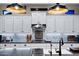 Close-up of the kitchen with white cabinets, designer backsplash, stainless steel appliances, and modern lighting at 2034 N Dome Rock --, Mesa, AZ 85207