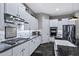 Gourmet kitchen featuring white cabinets, sleek countertops, stainless steel appliances, and ample counter space at 2034 N Dome Rock --, Mesa, AZ 85207
