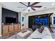 Bright living room with hardwood floors, ceiling fan, designer rug, and direct access to the backyard through glass sliding doors at 2034 N Dome Rock --, Mesa, AZ 85207