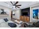 Open living room with hardwood flooring, a large TV, and access to the bedroom at 2034 N Dome Rock --, Mesa, AZ 85207