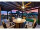 Relaxing outdoor patio area features a fire table, wood furniture, and a covered pergola with ceiling fan at 2034 N Dome Rock --, Mesa, AZ 85207
