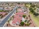 Aerial view of desert landscaping, a tile roof and lush green golf course in the distance at 20827 N Stonegate Dr, Sun City West, AZ 85375