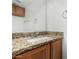 Bathroom featuring granite vanity with cabinets, a large mirror, and vanity lighting at 2842 E Beck Ln # 2, Phoenix, AZ 85032