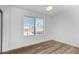 Bright bedroom with a large window offering plenty of natural light and hardwood floors at 2842 E Beck Ln # 2, Phoenix, AZ 85032