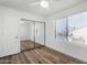 Spacious bedroom featuring a sliding mirrored closet and light hardwood flooring at 2842 E Beck Ln # 2, Phoenix, AZ 85032