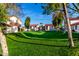 Expansive grassy common area surrounded by well-maintained buildings and mature shade trees at 2842 E Beck Ln # 2, Phoenix, AZ 85032