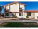 Two-story home featuring a white stucco facade, red tile roof, and a small front yard with desert landscaping at 2842 E Beck Ln # 2, Phoenix, AZ 85032